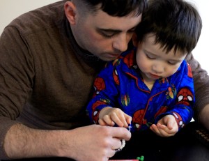 Little G and Daddy making the water cycle bracelet