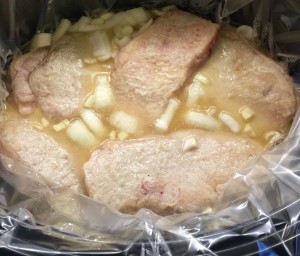 The BEST Pork Chops slow cooking in the crockpot